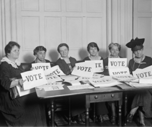 women holding vote signs