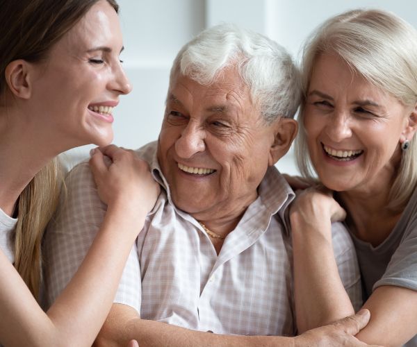 woman hugging older parents